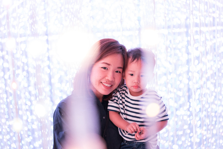 Mother and son in the LED light infinity room, Family among the star concept.の写真素材