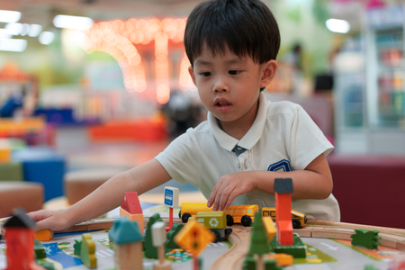 A boy is building the city by his toys.の写真素材