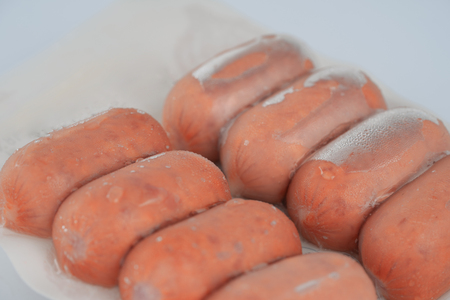 Sausages in plastic pack in white background.の写真素材
