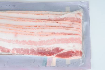 Bacons in plastic pack in white background.の写真素材