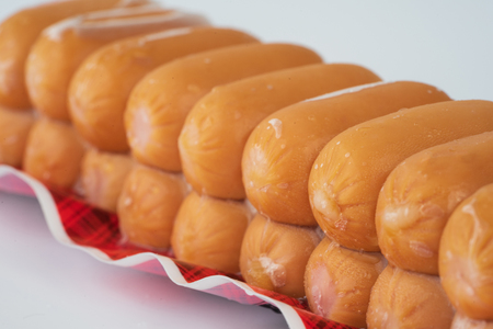 Sausages in plastic pack in white background.の写真素材