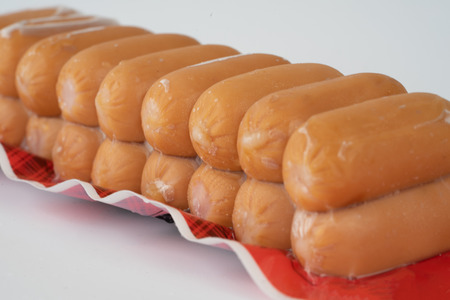 Sausages in plastic pack in white background.の写真素材