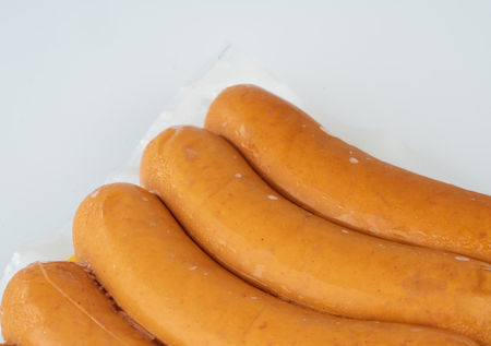 Sausages in plastic pack in white background.の写真素材