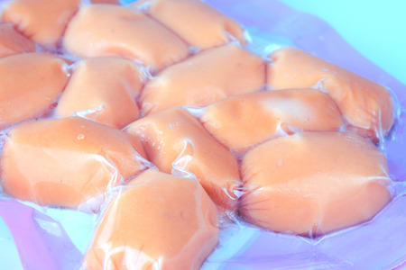 Sausages in plastic pack in white background.の写真素材