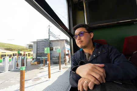 A working man travels and enjoy the beautiful view in train at Europe.の写真素材