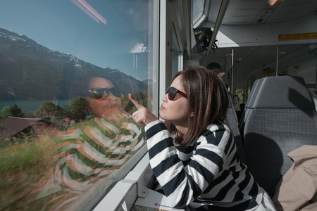 A working woman travels and enjoy the beautiful view in train at Europe.の写真素材