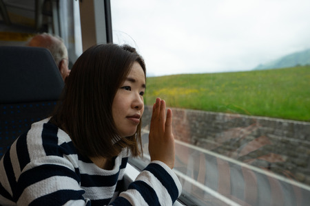 A working woman travels and enjoy the beautiful view in train at Europe.