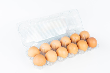 the pack of eggs in plastic packaging with white background.