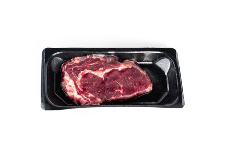 Raw steak in plastic pack in white background.の写真素材