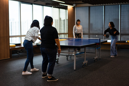 Girls is playing table tennis in free time at the office.の写真素材