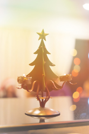 A Steel Christmas tree toy on the table at night.の写真素材