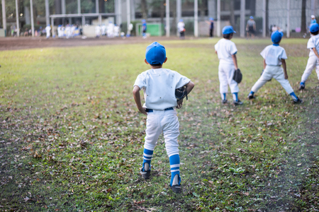 Baseball kid team is practicing hard in the field to prepare for next season's game.の写真素材