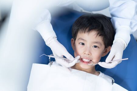 An Asian boy having teeth examined at dentists: Healthy lifestyle, healthcare, and medicine concept.の写真素材
