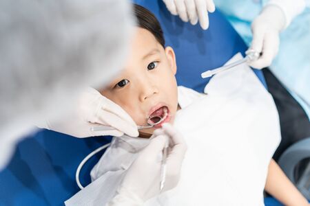 An Asian boy having teeth examined at dentists: Healthy lifestyle, healthcare, and medicine concept.の写真素材
