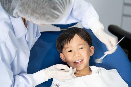 An Asian boy having teeth examined at dentists: Healthy lifestyle, healthcare, and medicine concept.の写真素材