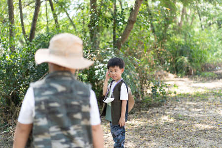 Adventure boys travel the jungle in Thailand.
