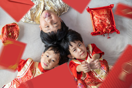 The children were delighted to receive the money in the red envelope on the Chinese new year.の写真素材