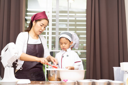 Mom and son are make bun for pizza. Little chef are making pizza.の写真素材