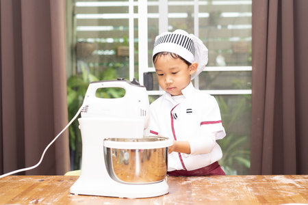A boy is make bun for pizza. Little chef is making pizza.