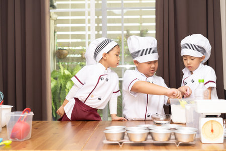 Brothers are make bun for burger. Little chefs are making burger.の写真素材