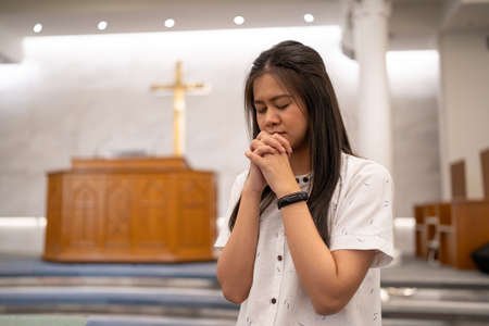 Asian women praying in a worship room in a Christian church.の写真素材