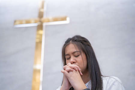 Asian women praying in a worship room in a Christian church.の写真素材