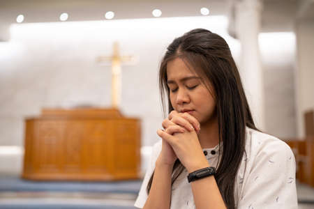 Asian women praying in a worship room in a Christian church.の写真素材