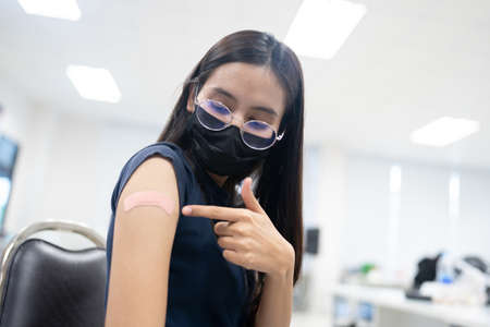 A woman received vaccines to prevent covid-19.の写真素材