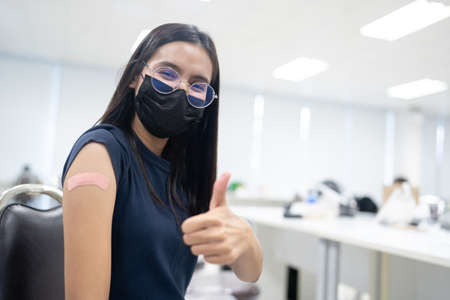 A happy woman received vaccines to prevent covid-19.の写真素材
