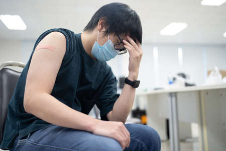 A man headache because side effect of vaccine.の写真素材