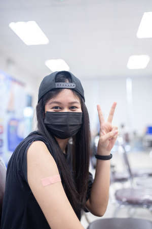 A happy woman received vaccines to prevent covid-19.の写真素材