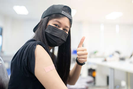 A happy woman received vaccines to prevent covid-19.の写真素材