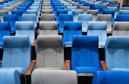 the empty theatre, conference room with many blue and gray seats.の写真素材
