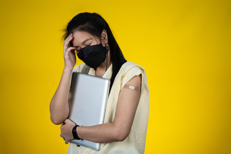 A working woman headache because vaccine side effect.の写真素材