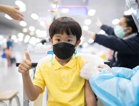 A boy gets get vaccinated against COVID-19.の写真素材