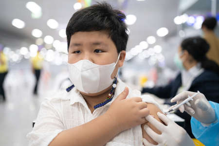 A boy gets get vaccinated against COVID-19.の写真素材