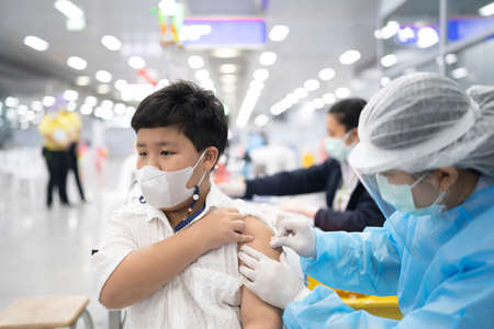 A boy gets get vaccinated against COVID-19.の写真素材