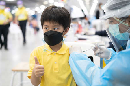 A boy gets get vaccinated against COVID-19.の写真素材