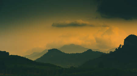 The light of the sun is setting along the mountains and fertile forests at Klong Phawa Yai Reservoir, Kaeng Hang, Chanthaburi, Thailand.の写真素材