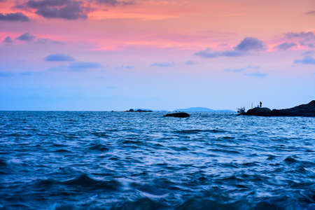 A picture of a fishing man in the evening At Phayun Beach, Ban Chang, Rayong, Thailandの写真素材