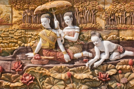 Thai culture stone carving on temple wallの写真素材