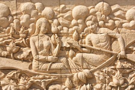 Thai culture stone carving on temple wallの写真素材