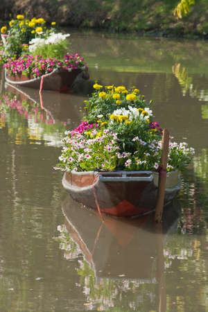 Boat of colorful flowers floating on lake の写真素材