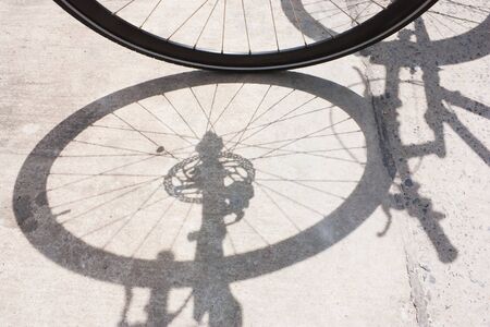 Bicycle wheel and shadow on blackgroundの写真素材