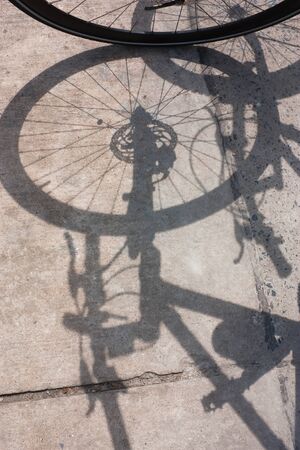 Bicycle wheel and shadow on blackground