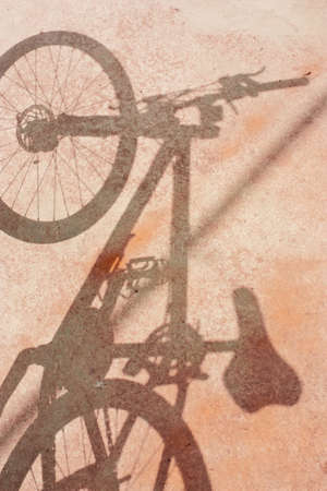 Bicycle wheel and shadow on grunge blackgroundの写真素材