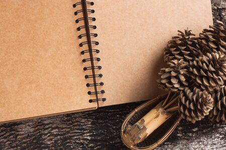 Blank recycled notebook  on grunge wooden backgroundの写真素材
