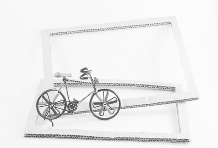 Wire bicycle model,paper frame on white background with monochrome imageの写真素材