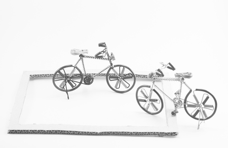 Wire bicycle model,paper frame on white background with monochrome imageの写真素材