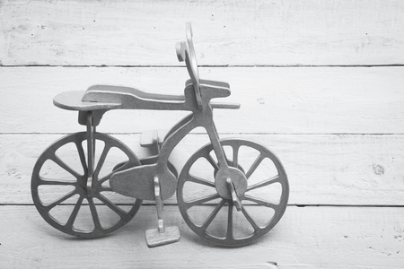 Retro wood bicycle on wood backgroundの写真素材